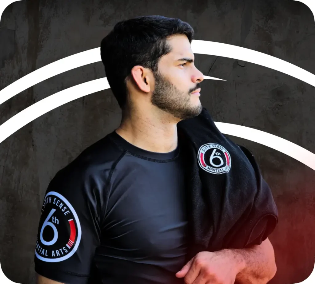 Mattheus Galvaou is wearing Sixth Sense Martial Arts Merch with a Gi hung over his shoulder | jiu jitsu classes | Sixth Sense Martial Arts | Coppell, TX