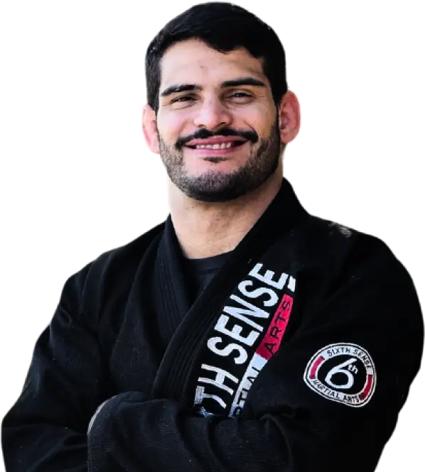 Expert Coach Mattheus Galvao wearing a black GI with the Sixth Sense Martial Arts Logo on it | mma lessons near me